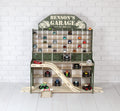 Full view of smaller wooden toy car garage with ramps, LED lights and display shelves