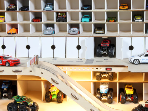 Close-up of toy car storage garage shelves with ramp, doors and LED lighting