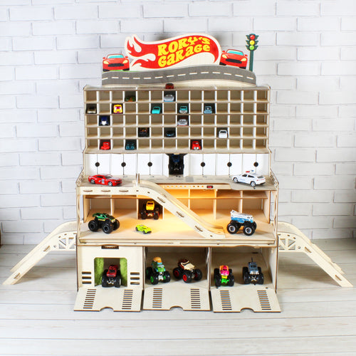 Front view of large wooden toy car garage with ramps, storage drawers and 1:64 cars