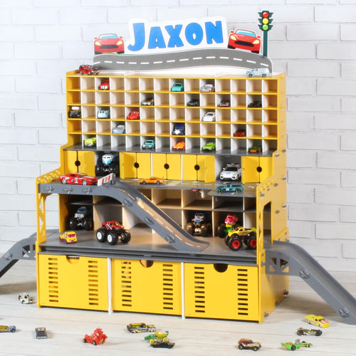 Front view of yellow toy car parking garage with Jaxon nameplate, shelves and display cars