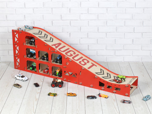 Full side view of red personalized wooden toy car ramp for 1:64 cars with storage compartments