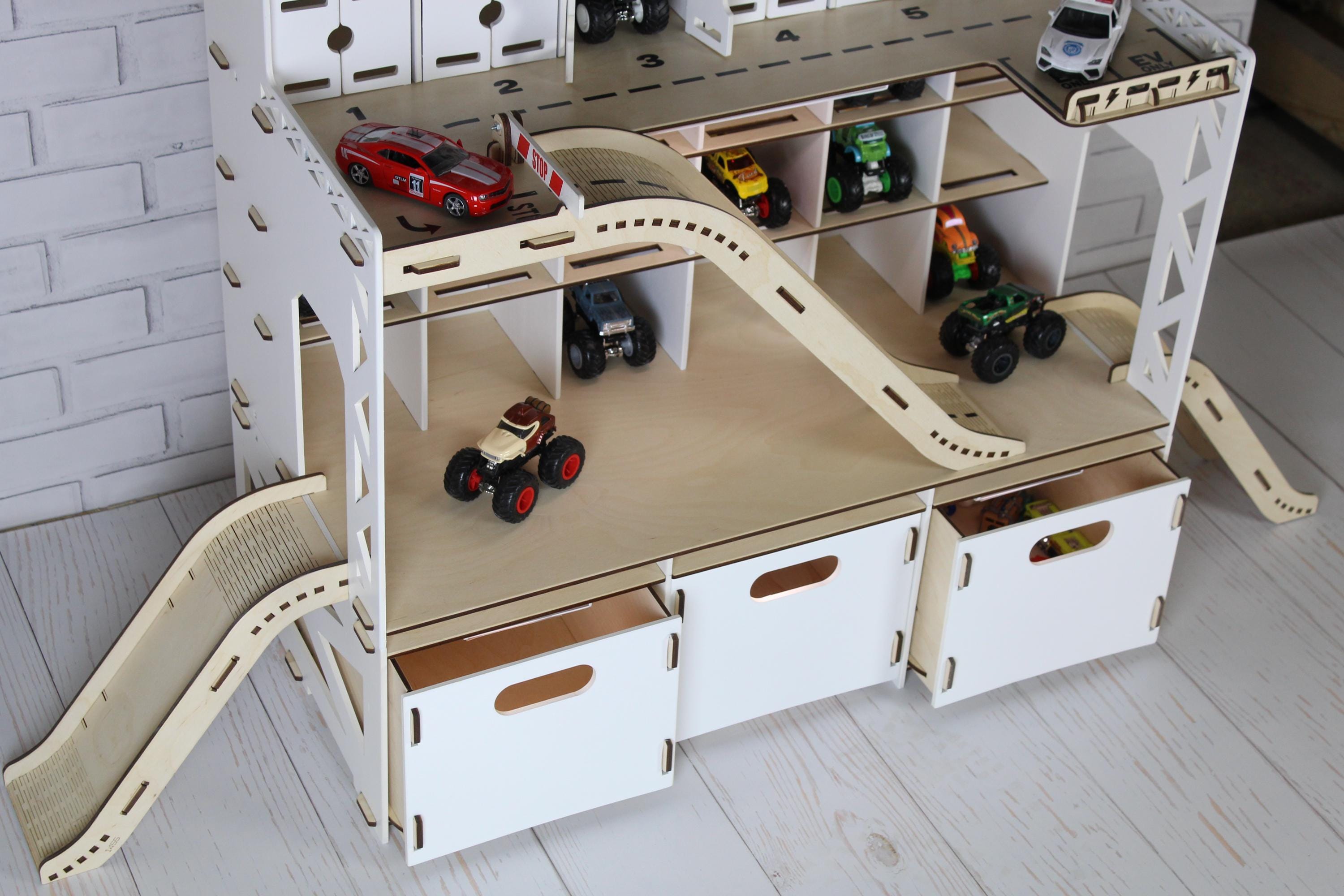 White wooden toy car garage with ramp, parking shelves and lower storage compartments, bottom view