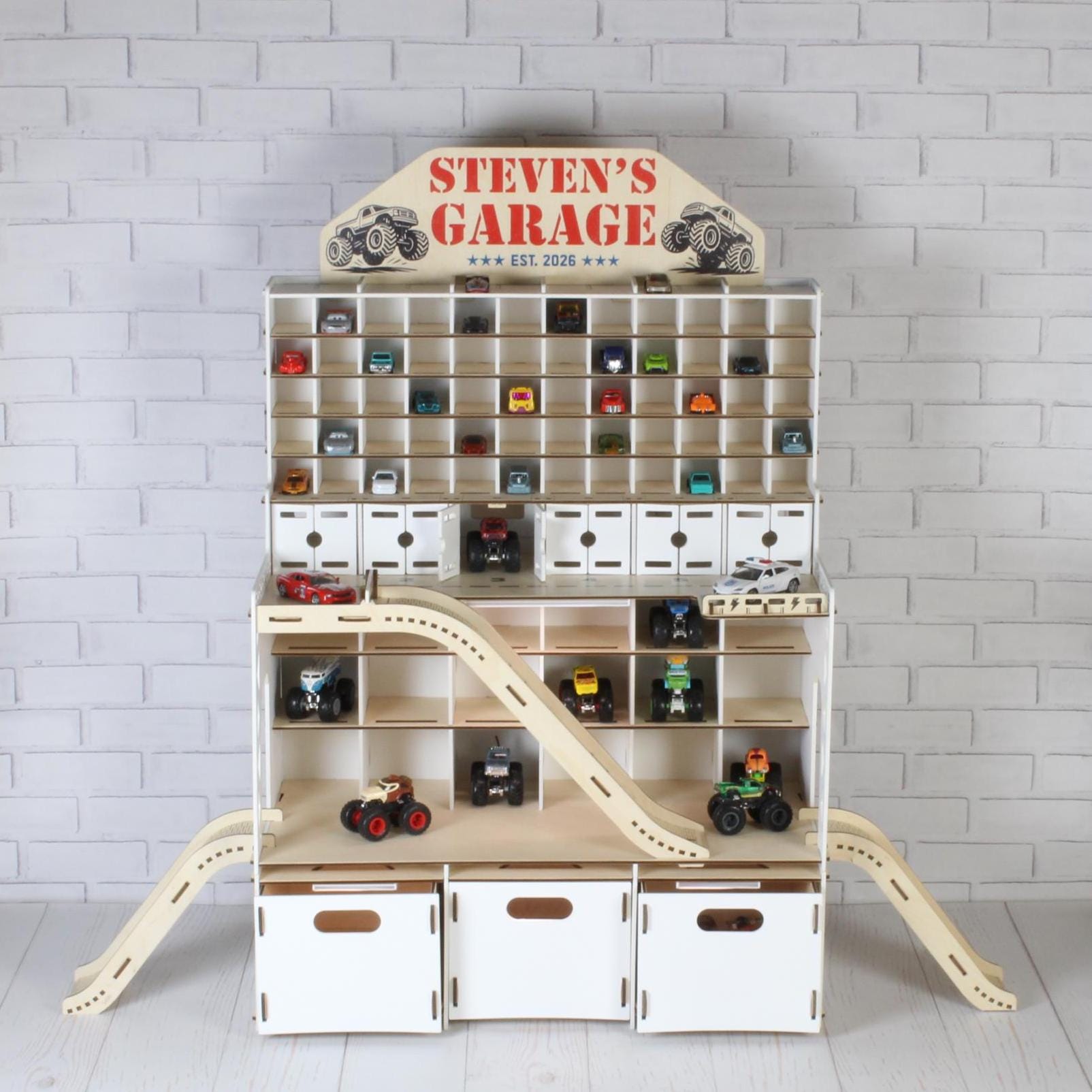 White wooden toy car garage for 1:64 cars with ramps, LED lights and Steven’s Garage nameplate