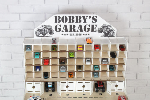 Wooden toy car storage garage with open shelves and Bobby’s Garage nameplate