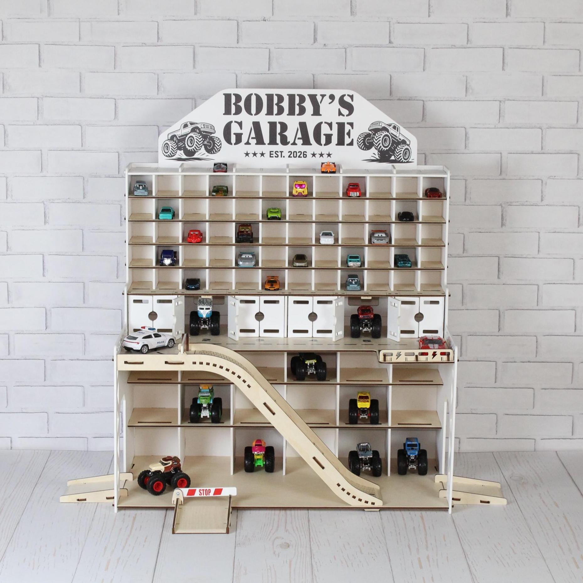 Small wooden toy car garage for 1:64 cars with ramps, LED lights and Bobby’s Garage nameplate