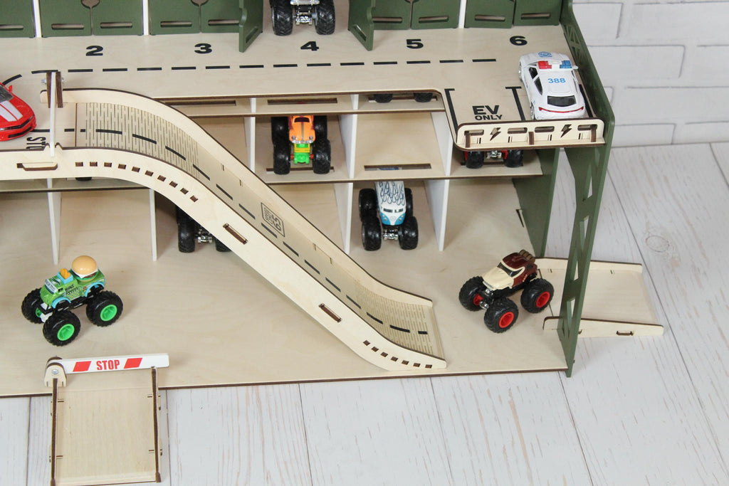 Wooden toy car parking garage close-up with ramp, road markings and toy cars