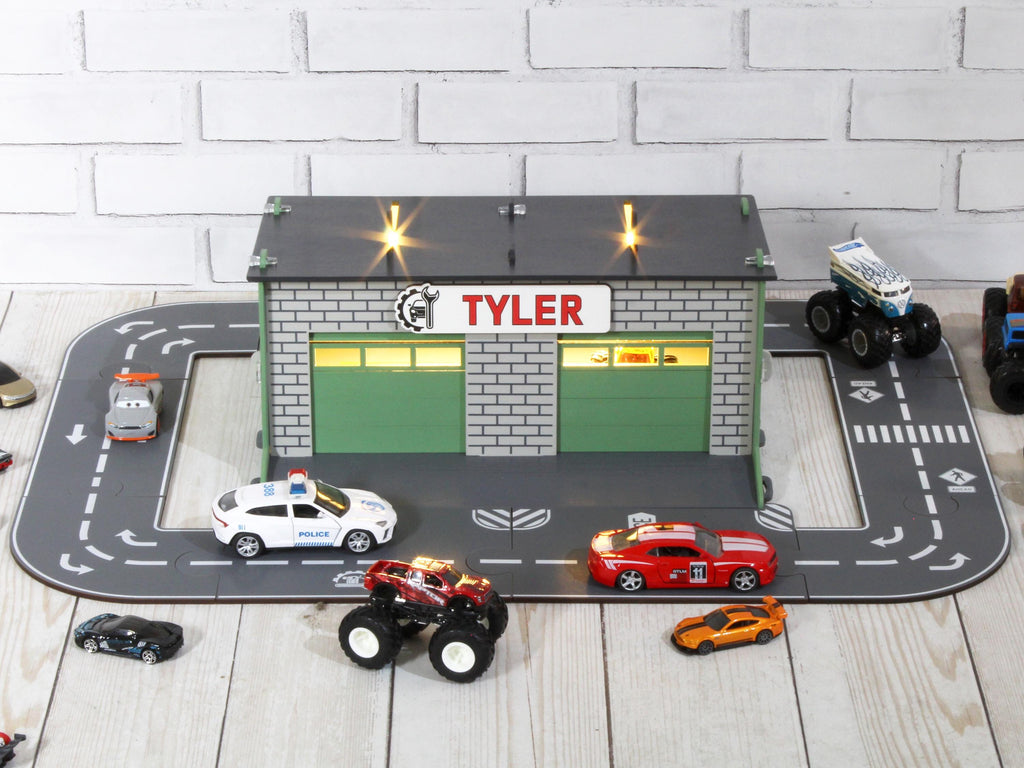 Front view of wooden toy car garage with custom nameplate and round road track