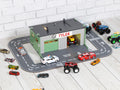 Full angled view of wooden toy car garage with round road track and 1:64 cars