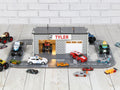 Front view of wooden toy car garage with round road track, LED lights and 1:64 cars