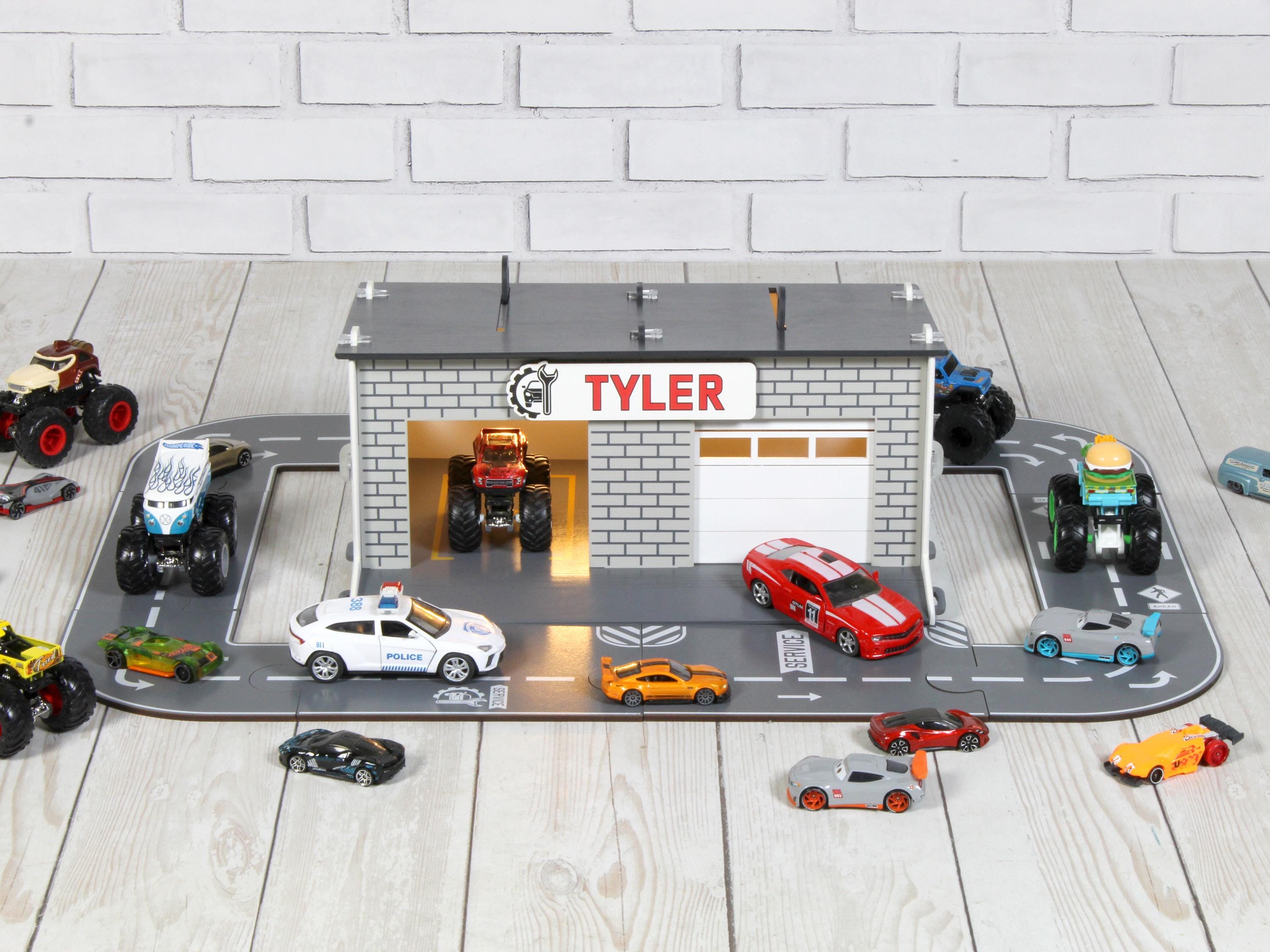Front view of wooden toy car garage with round road track, LED lights and 1:64 cars