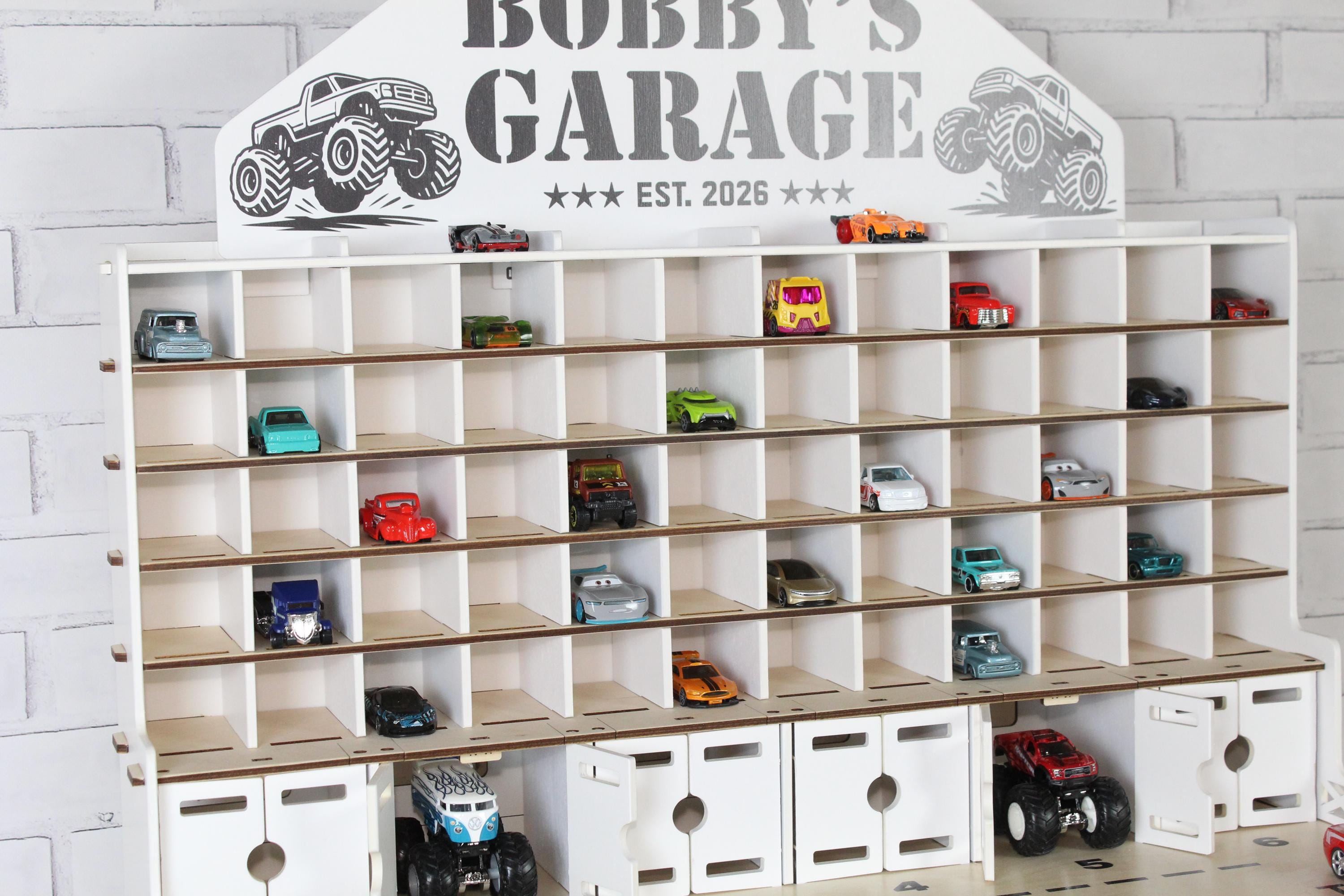 Small wooden toy car garage close-up with 1:64 car shelves and nameplate