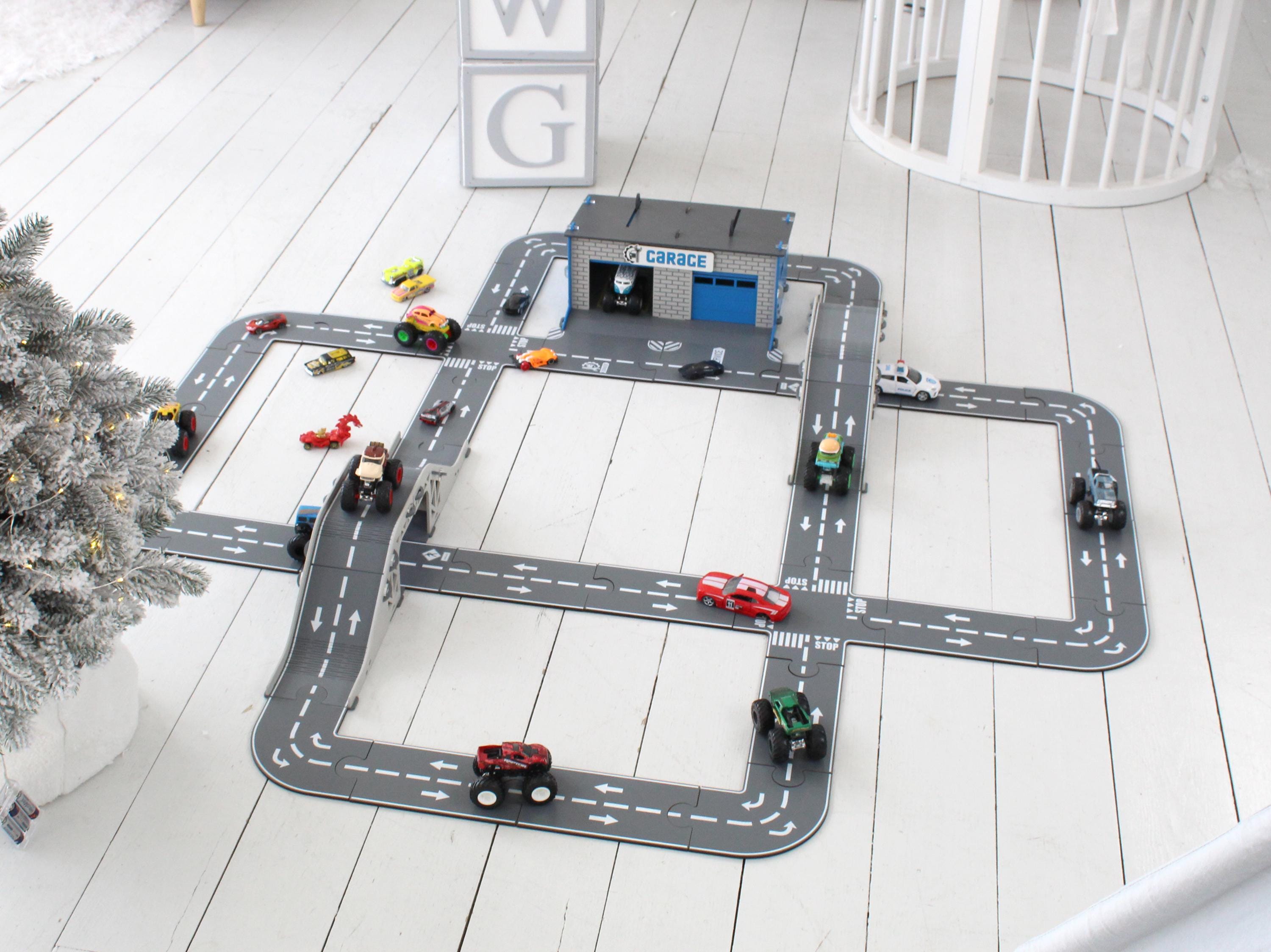 Angled view of wooden toy car road track with parking area and diecast cars