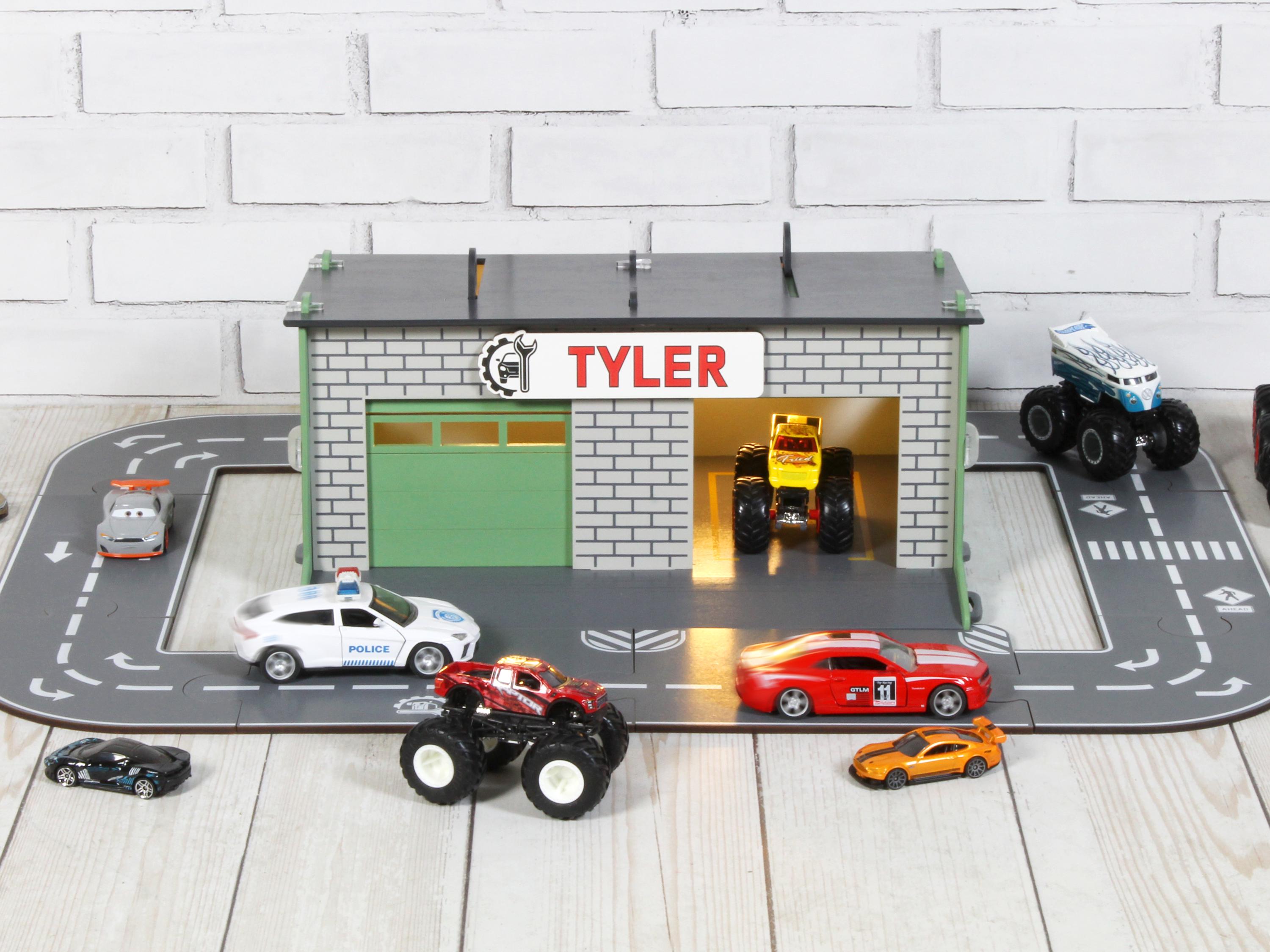 Close-up front view of wooden toy car garage with LED lights, open door and 1:64 cars