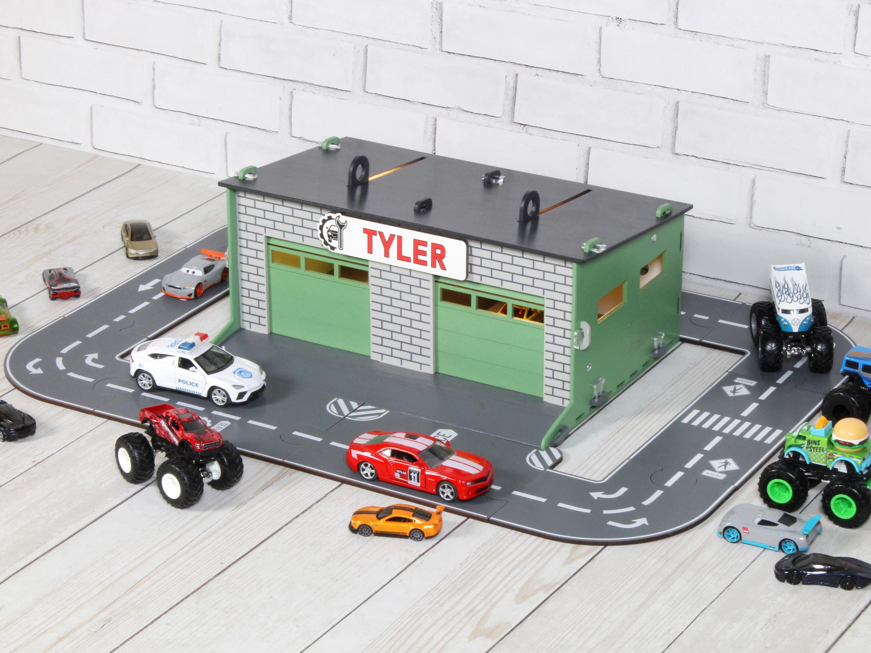Side view of wooden toy car garage with round road playset and toy cars